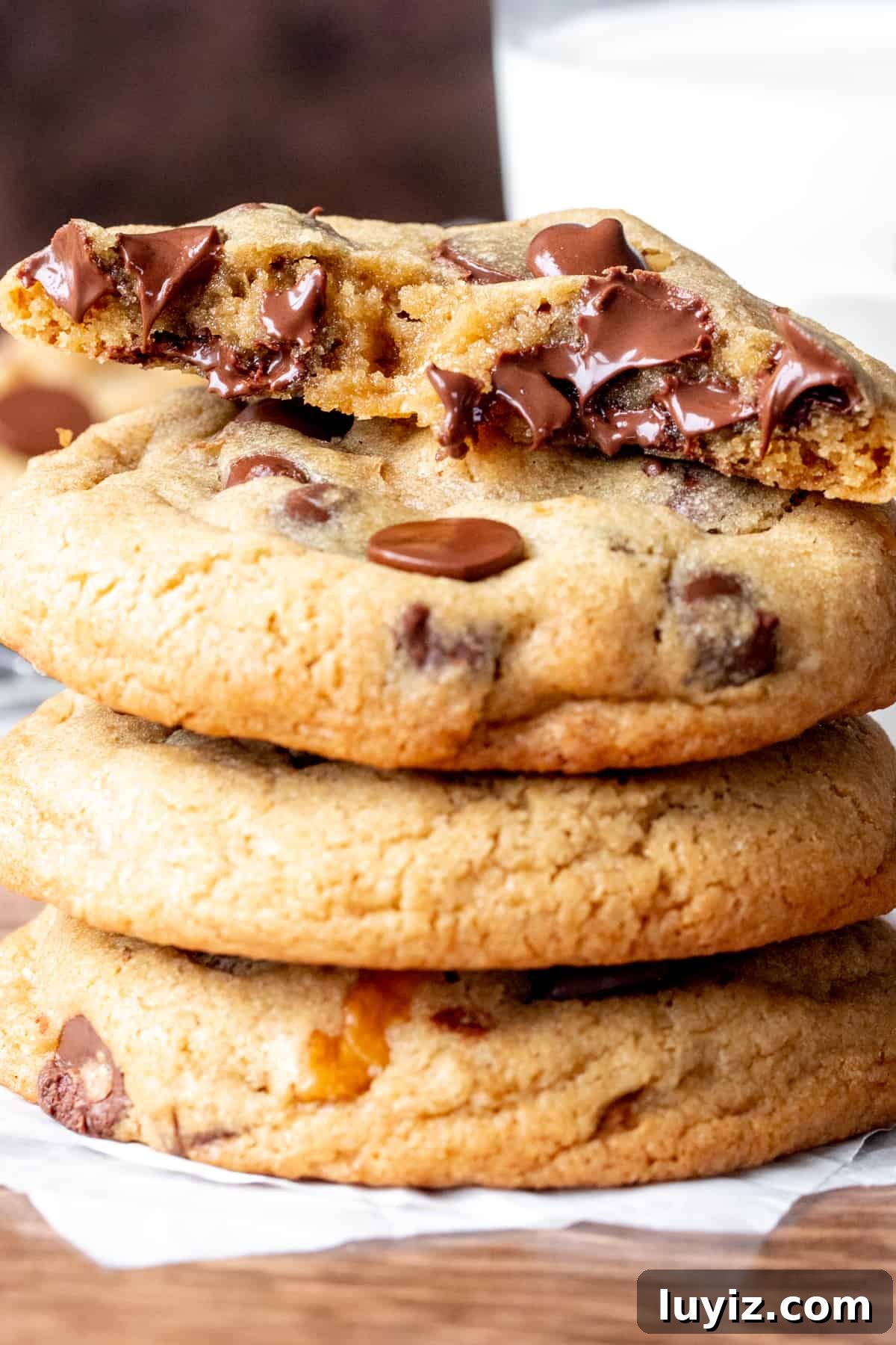 Crispy Chocolate Chip Walnut Cookies Recipe for Home Bakers 5 4 walnut chocolate chip cookies on top of each other, with top cookie broken in half