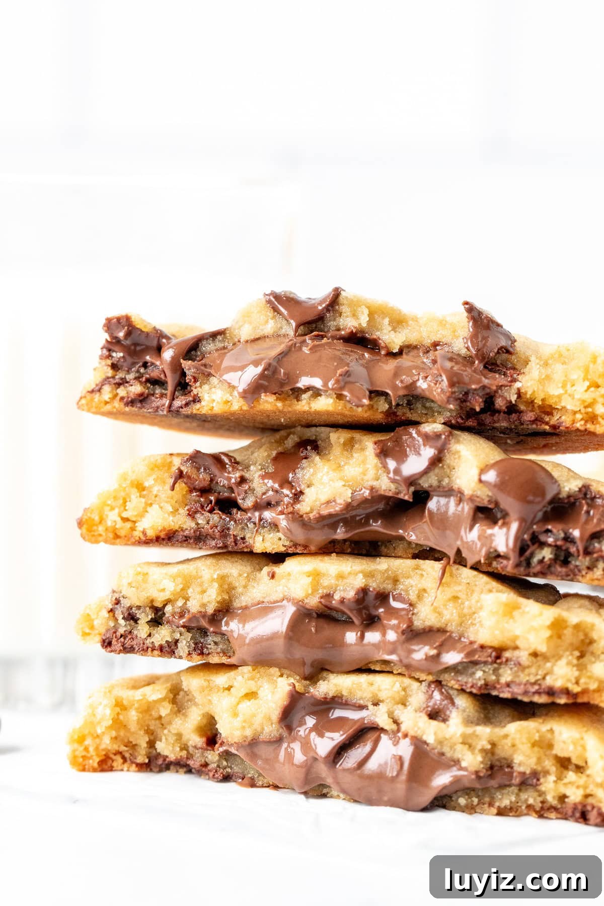 Decadent Nutella-Filled Chocolate Chip Cookies 2 Stack of Nutella stuffed cookies, broken in half