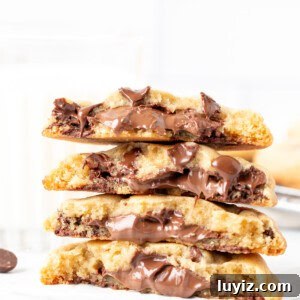 Decadent Nutella-Filled Chocolate Chip Cookies 9 Nutella chocolate chip cookies, broken in half and stacked on top of each other