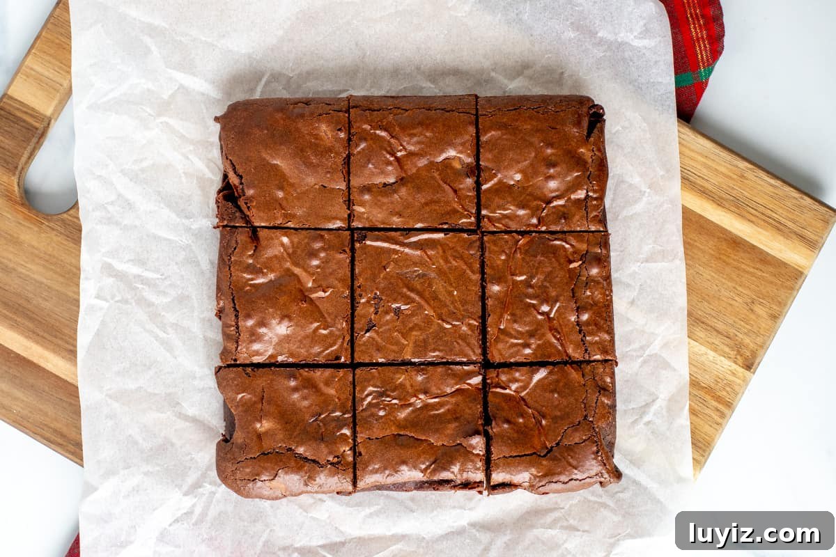 Gingerbread Brownies Recipe: Fudgy Spiced Chocolate Treat 8 Brownies on a cutting board cut into 9 pieces.
