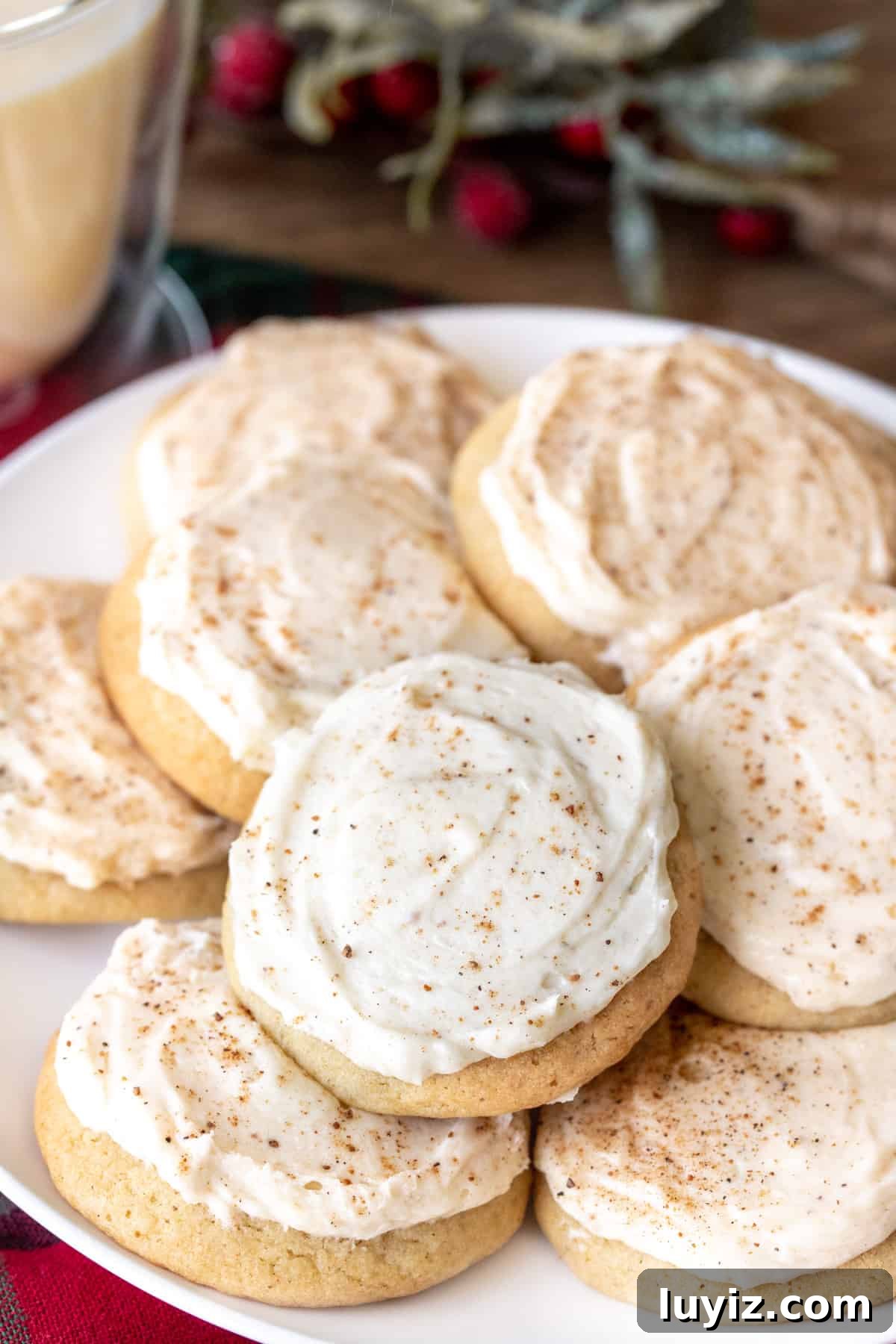 Eggnog Cookies with Creamy Eggnog Frosting — Holiday Cookie Recipe 4 Plate of eggnog cookies frosted with eggnog buttercream and sprinkled with nutmeg