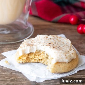 Eggnog Cookies with Creamy Eggnog Frosting — Holiday Cookie Recipe 5 Eggnog cookie with eggnog buttercream with a bite taken out