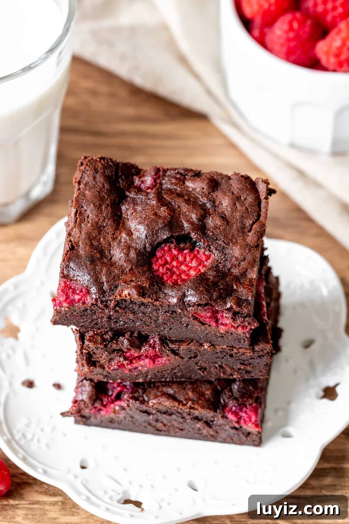 Decadent Raspberry Swirl Brownies: Fudgy Chocolate Raspberry Bars 3 Three brownies studded with raspberries, stacked on top of each other