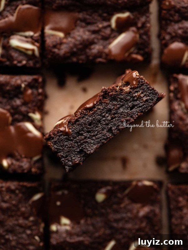 How to Make Classic Homemade Peppermint Patties at Home 11 Double chocolate mint brownies on brown parchment paper background with the center brownie on its side.