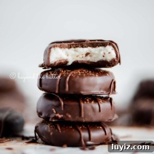How to Make Classic Homemade Peppermint Patties at Home 14 Stack of 4 peppermint patties surrounded by more peppermint patties with white background.