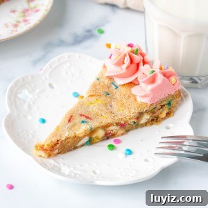 Funfetti Cookie Cake Recipe with Sprinkle-Filled Frosting 5 Slice of funfetti sugar cookie cake