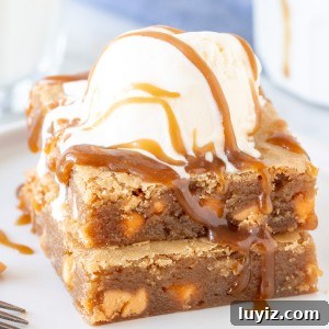 Chewy Butterscotch Blondies Recipe for Rich, Gooey Bars 5 Stack of butterscotch blondies with a scoop of ice cream on top