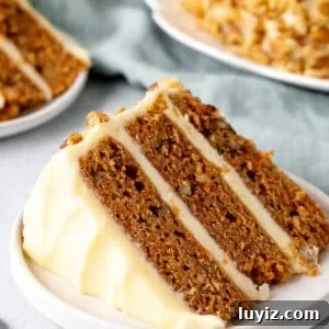 Slice of carrot cake layer cake with cream cheese icing