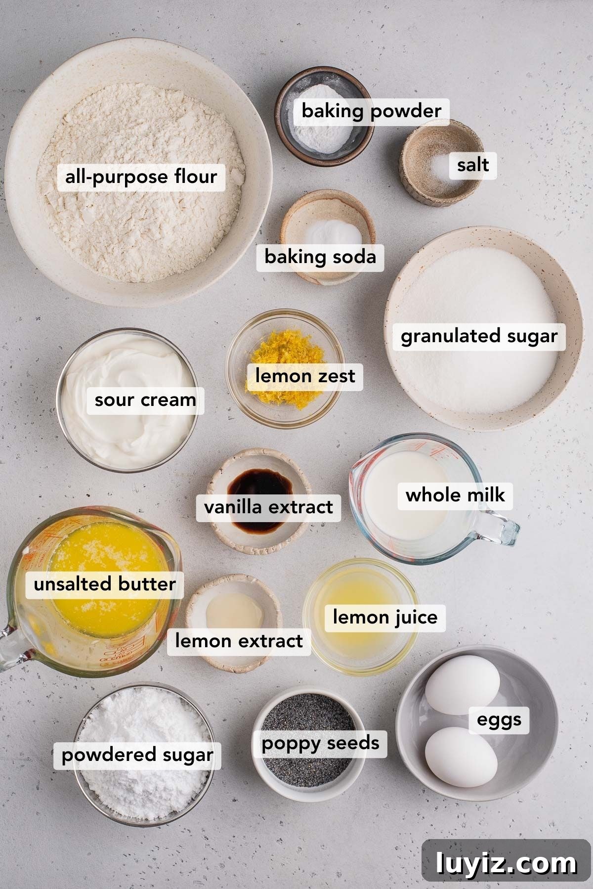 Lemon Poppy Seed Muffins with Zesty Glaze Recipe 3 Bowls of different ingredients to make lemon poppy seed muffins on light gray background.