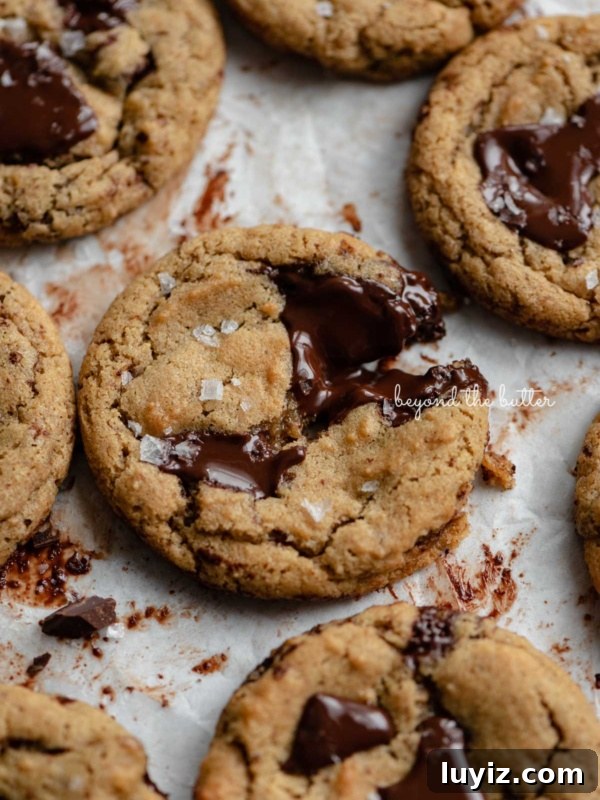 Fluffernutter Sandwich Cookies with Peanut Butter & Marshmallow Filling 15 Small batch gluten-free peanut butter chocolate chunk cookies on a parchment paper lined baking sheet.