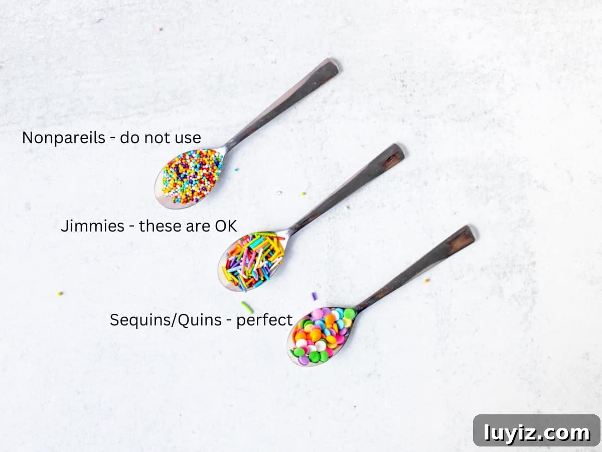 Funfetti Cheesecake Recipe: Colorful Layered Birthday Dessert 5 Three spoons holding 3 types of sprinkles