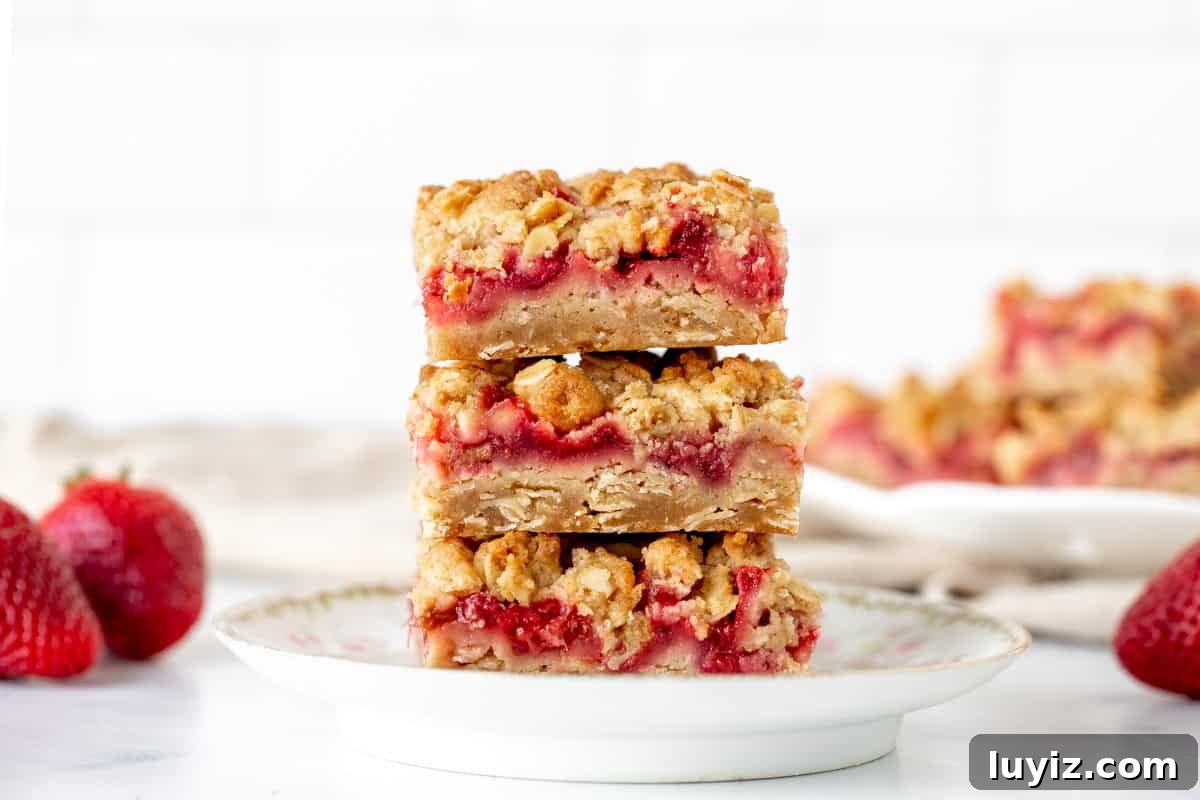 Strawberry Rhubarb Dessert Bars with Oat Crumble 6 Stack of 3 strawberry rhubarb oatmeal bars.