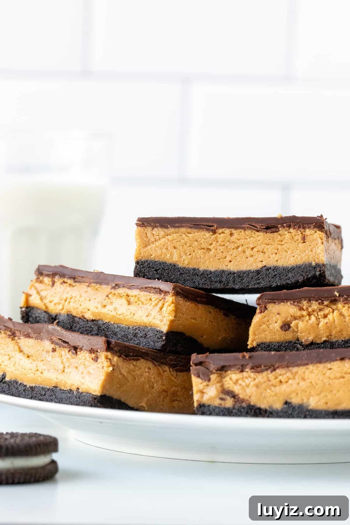Oreo Peanut Butter Bars Recipe — No-Bake Dessert Squares 3 Plate of Reese's Oreo peanut butter bars stacked on top of each other.