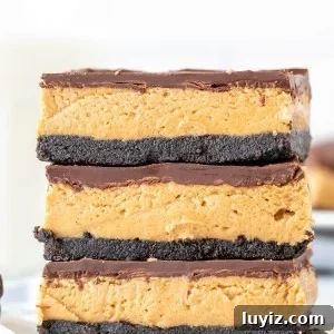 Oreo Peanut Butter Bars Recipe — No-Bake Dessert Squares 8 Stack of 3 peanut butter Oreo bars, one on top of each other.