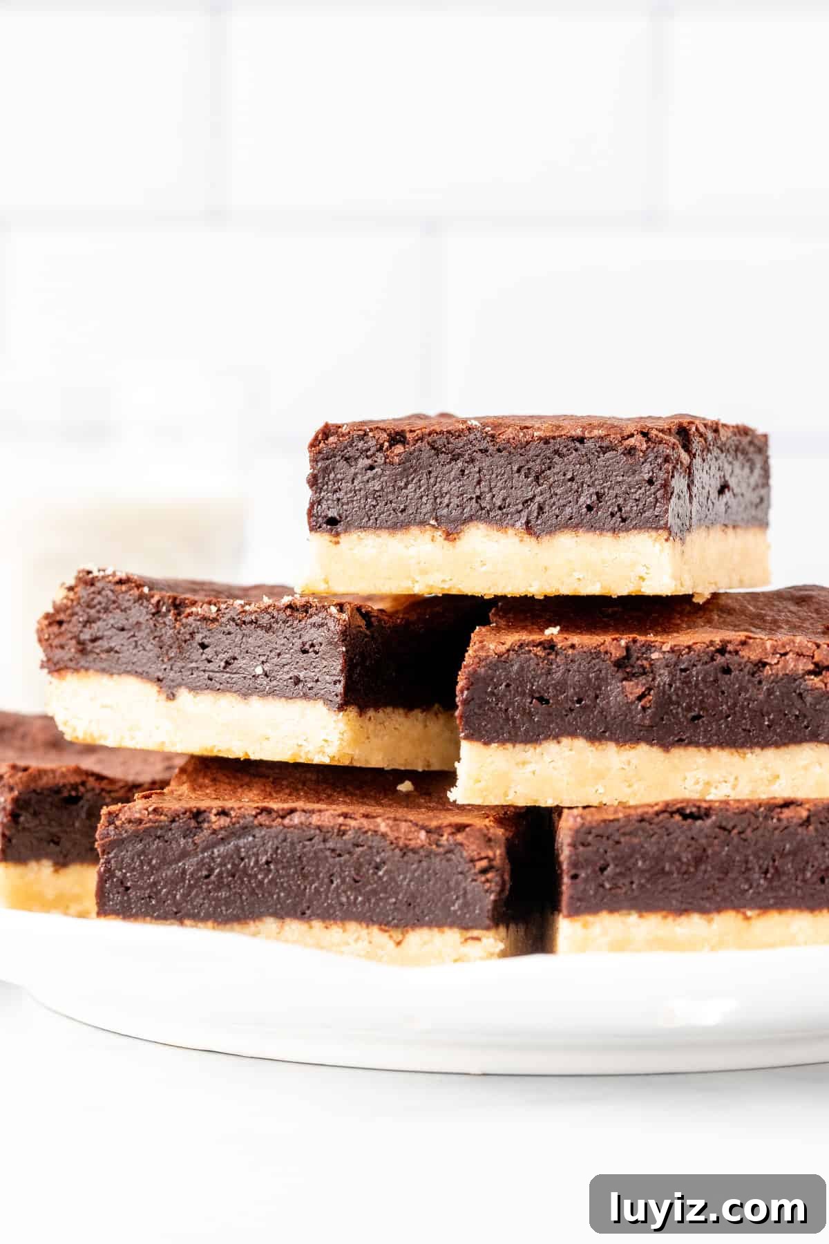 Shortbread Brownies Recipe: Buttery Crumb-Topped Chocolate Bars 3 Plate of shortbread brownies, stacked on top of each other.