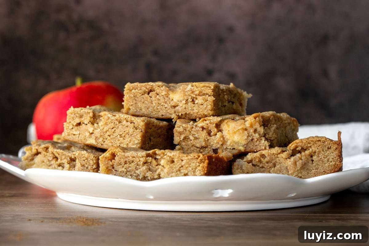 Cinnamon Apple Blondies — Soft, Chewy, Spiced Bite-Sized Treats 3 Large plate of cinnamon apple blondies, piled on top of each other