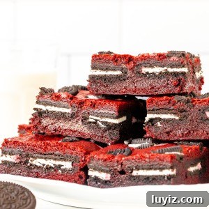 Red Velvet Brownie Bars Stuffed with Oreo Cookies 7 Plate of Oreo red velvet brownies, stacked on top of each other.