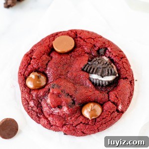 Oreo Red Velvet Cookie Recipe: Cream Cheese Frosting Twist 8 Close up of Oreo red velvet cookie topped with Oreo pieces and chocolate chips