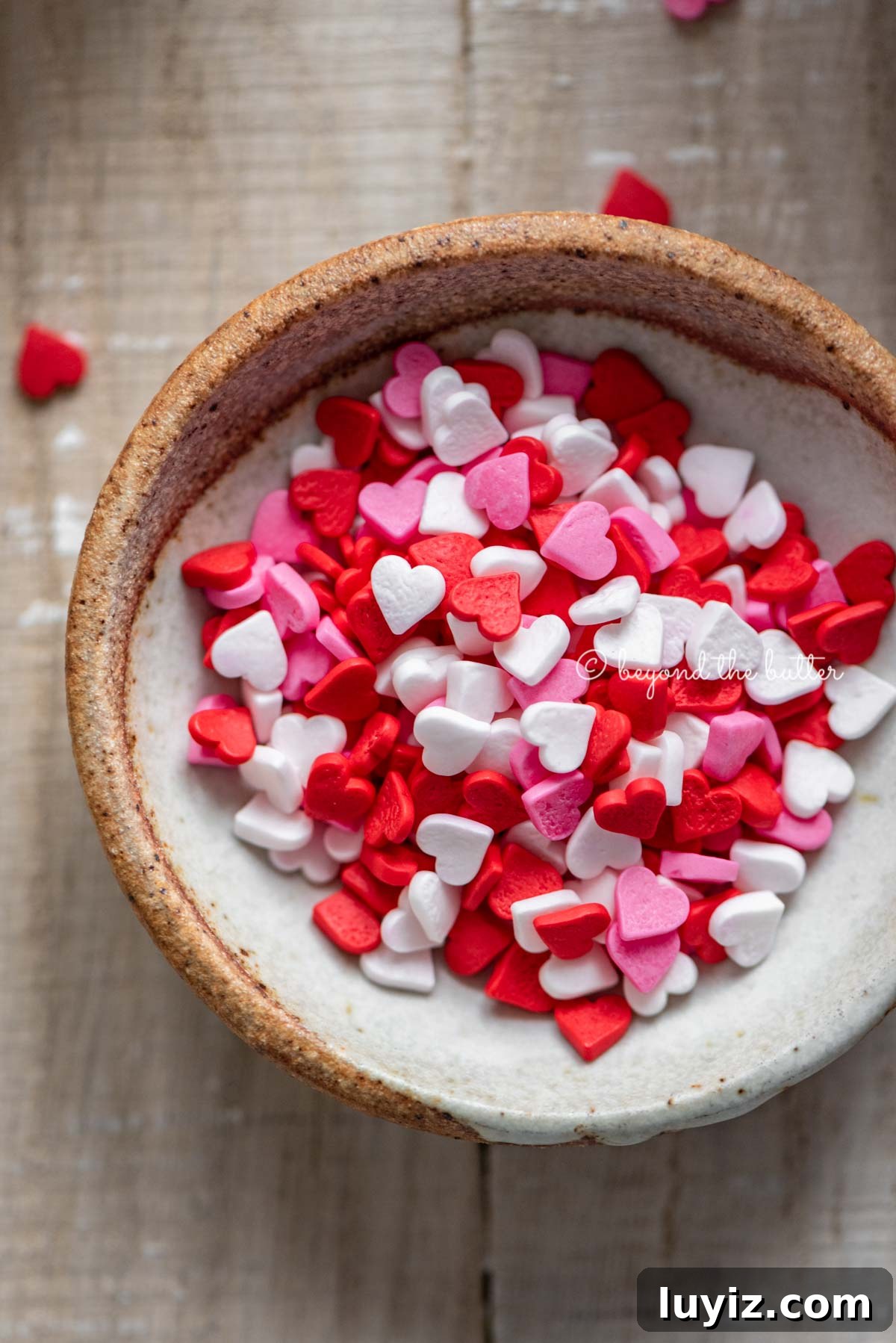 Perfect Red Velvet Cupcakes Recipe for Moist, Fluffy Results 8 Small bowl of Valentine's Day heart sprinkles Homemade red velvet cupcakes with one opened and half eaten with a small bowl of Valentine's Day sprinkles on light wood background | All images © Beyond the Butter®