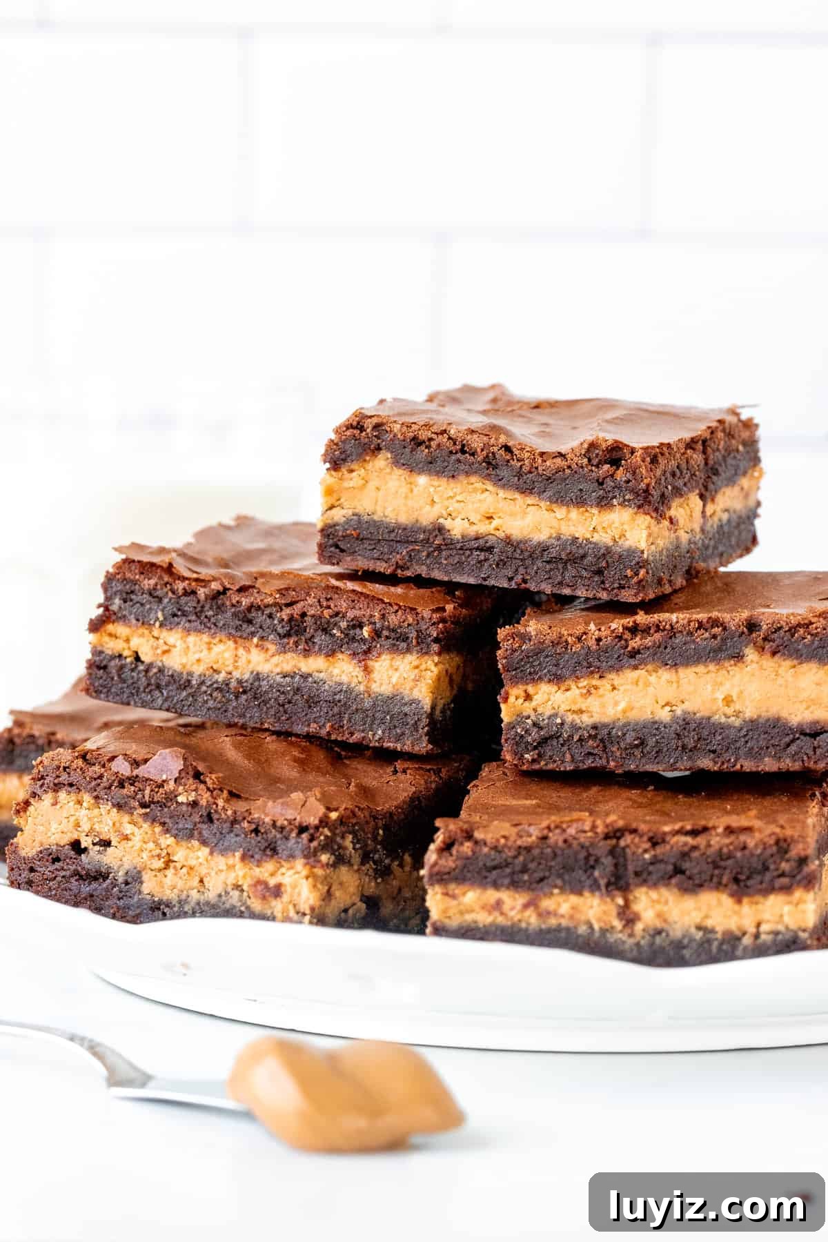 Decadent Peanut Butter-Stuffed Brownies Recipe 3 Plate of brownies made with peanut butter in the middle