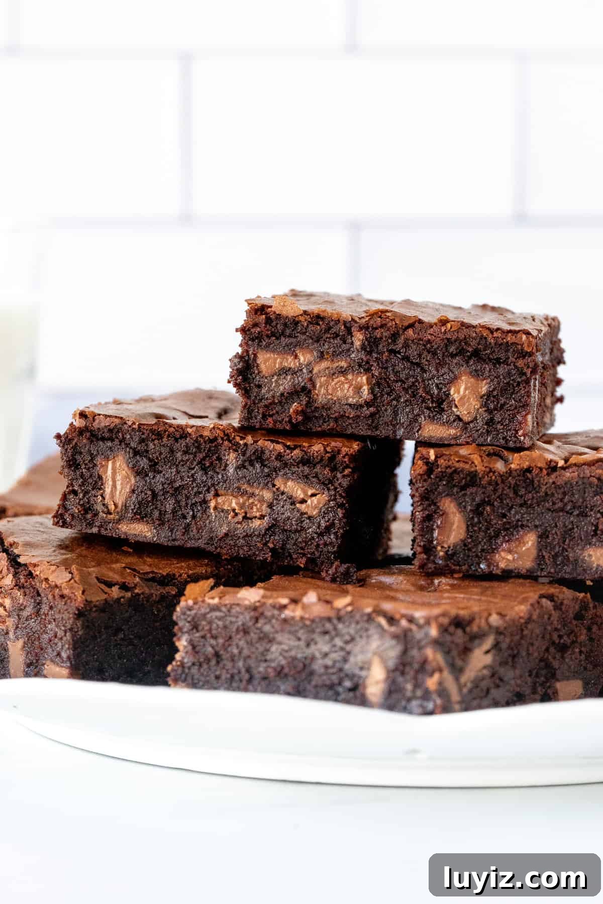 Decadent Chocolate Orange Brownies with Zesty Citrus Glaze 7 Plate of chocolate orange brownies with chunks of orange chocolate