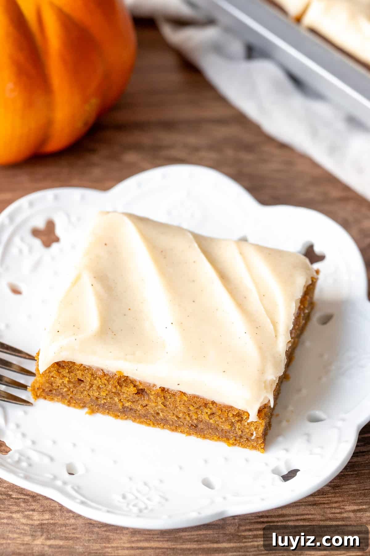 Pumpkin Bars with Cinnamon Cream Cheese Frosting Recipe 2 Pumpkin bar with cinnamon cream cheese frosting on a plate
