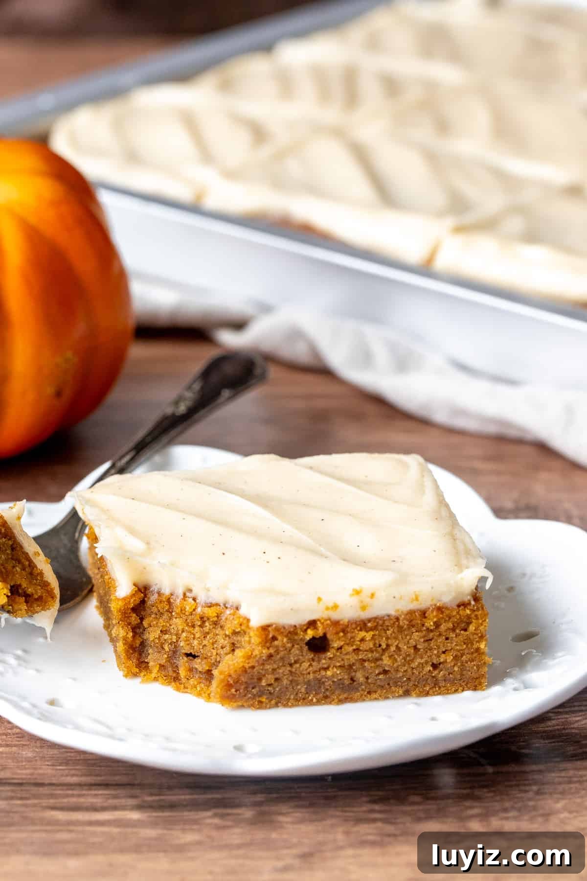Pumpkin Bars with Cinnamon Cream Cheese Frosting Recipe 6 Pumpkin bar with cream cheese frosting with a bite taken out
