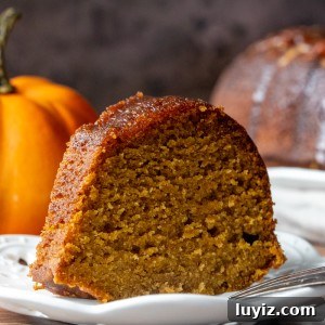 Spiced Pumpkin Rum Cake Recipe for Fall Gatherings 7 Slice of pumpkin rum bunt cake with mini pumpkin