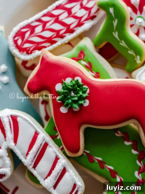 Classic Peanut Butter Blossom Cookies Recipe 12 Closeup of holiday cut out sugar cookies on a red and white plate