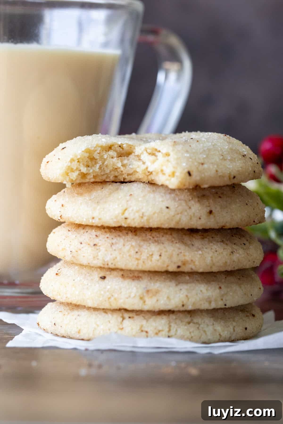 Eggnog Snickerdoodle Cookies: Festive Holiday Cookie Recipe 9 Stack of eggnog cookies with a bite taken out of the cookie on top