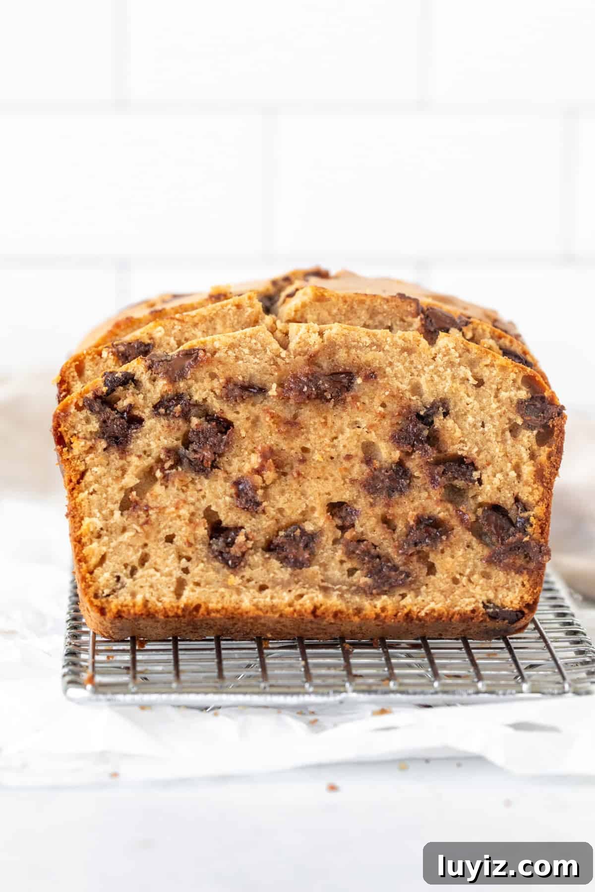 Peanut Butter Chocolate Chip Quick Bread Recipe 3 Slices of peanut butter bread on a wire rack