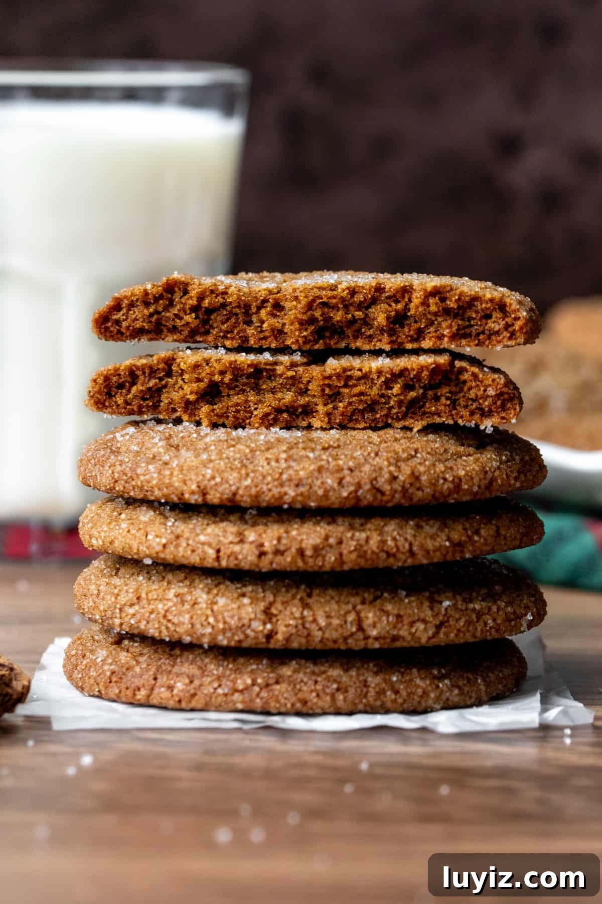 Crisp Gingersnap Cookies: A Classic Recipe for Snappy Texture 5 Stack of gingersnap cookies, with top cookie broken in half and glass of milk