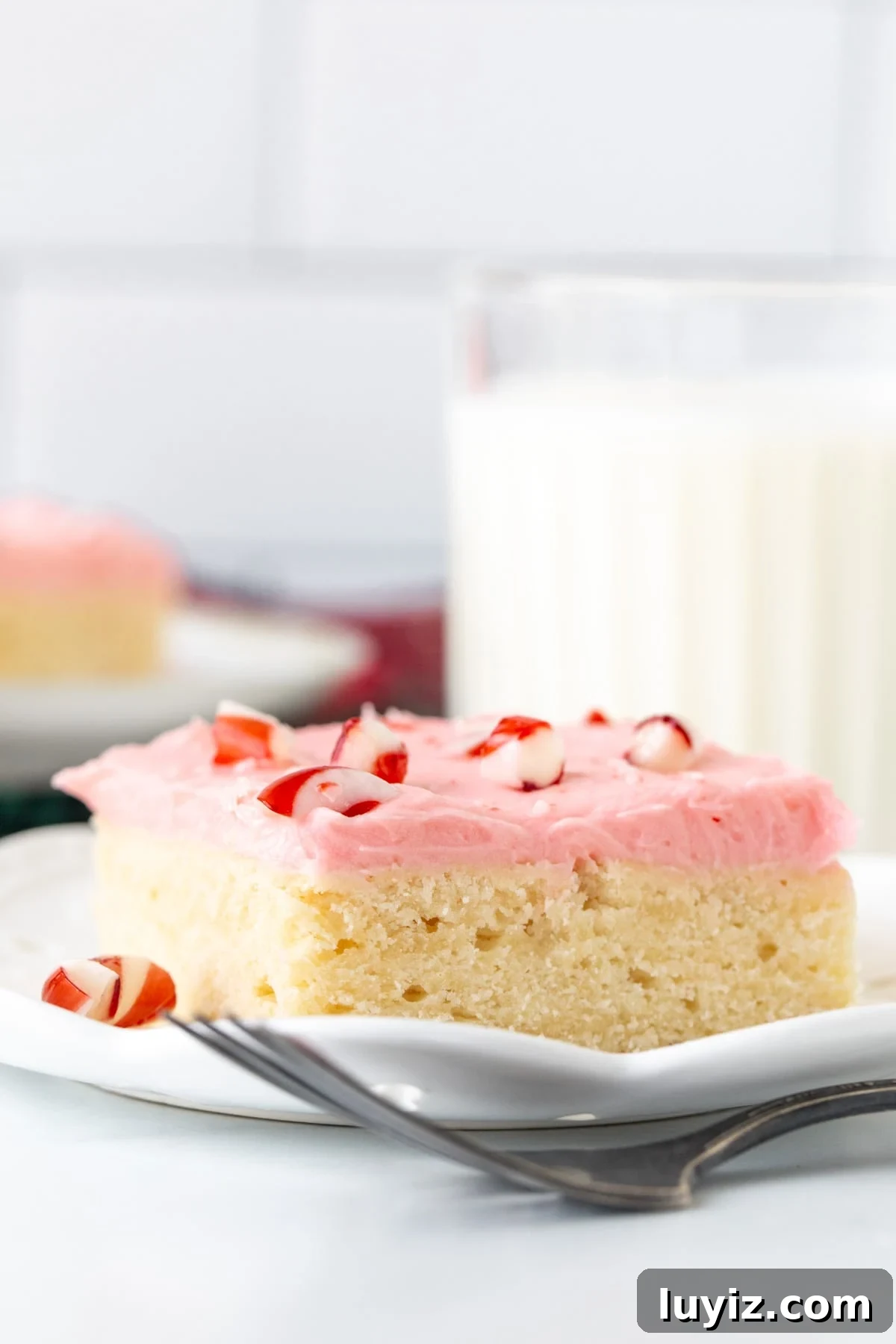 Peppermint Sugar Cookie Bars Recipe — Festive Holiday Dessert 3 Sugar cookie bar topped with pink peppermint frosting and crushed candy canes on top