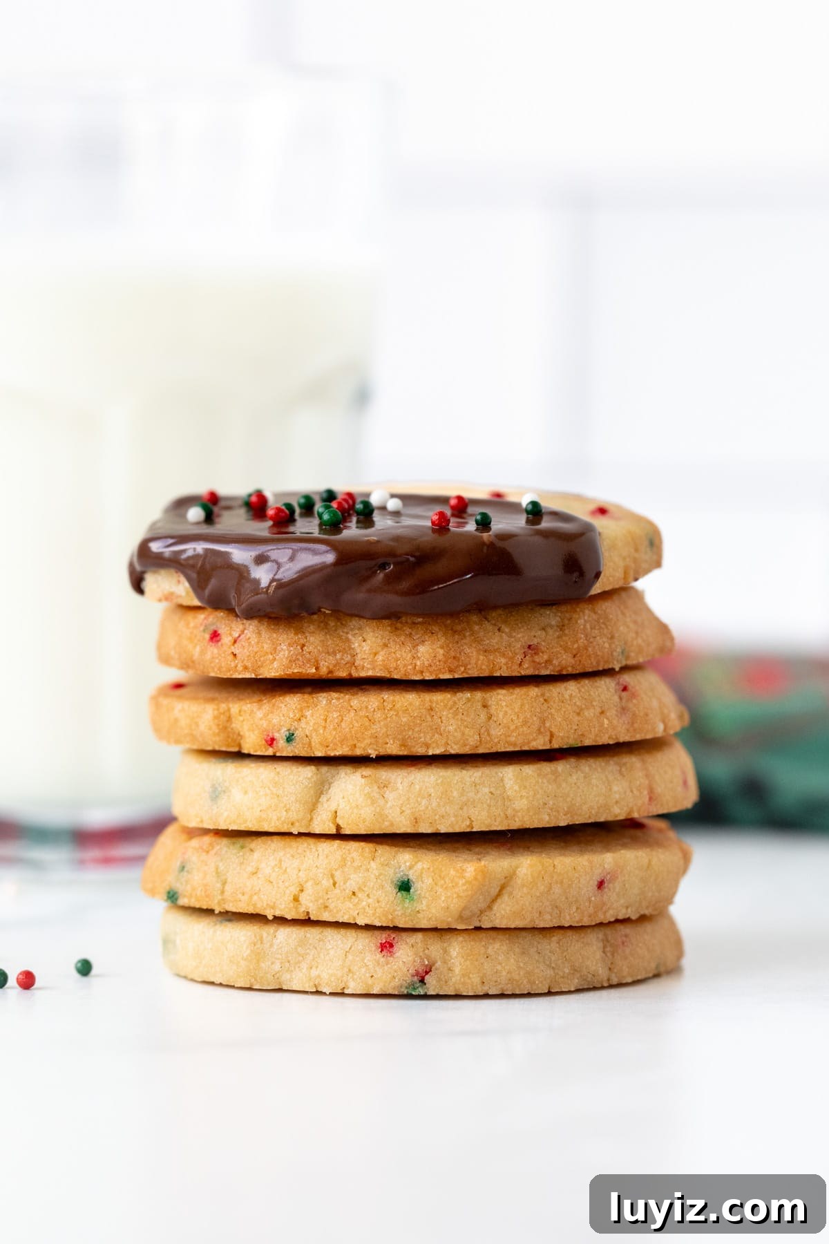 Christmas Sprinkle Slice-and-Bake Cookies: Festive Holiday Recipe 5 Stack of Christmas sprinkle slice and bake cookies, with top cookie dipped in chocolate