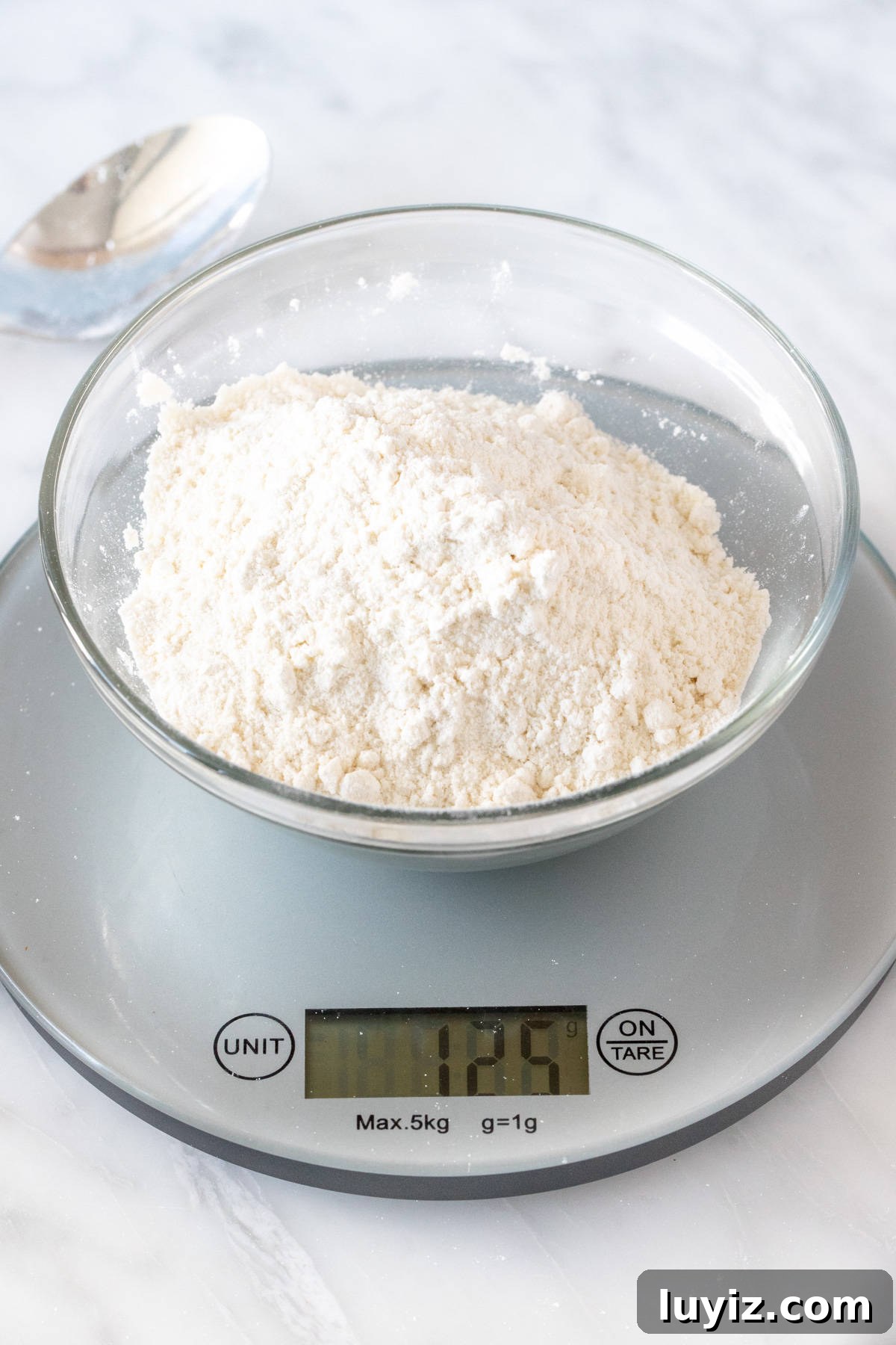 How to Measure Flour Accurately With or Without a Scale 3 Bowl of flour on kitchen scale with 125 grams