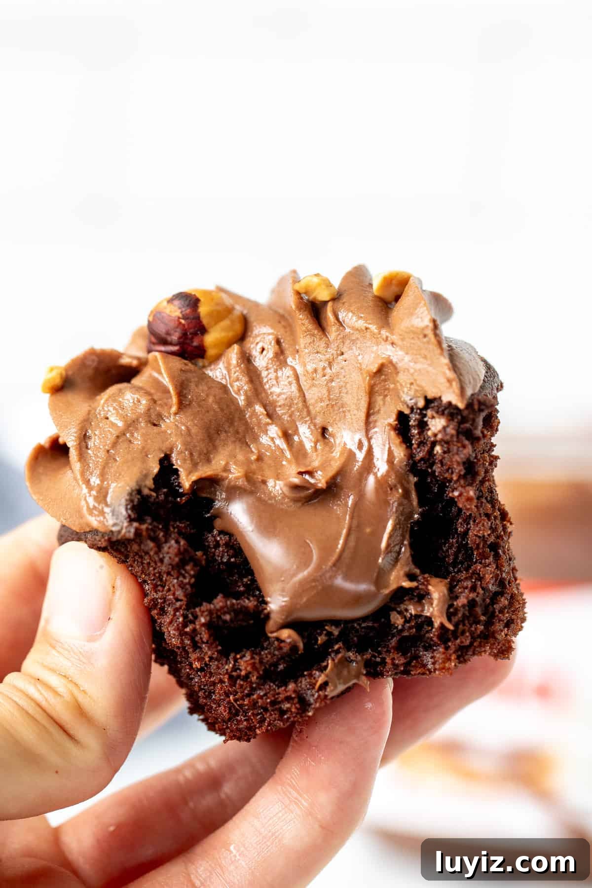 Decadent Nutella Cupcakes Recipe with Chocolate Hazelnut Swirl 6 Nutella stuffed cupcake with a bite taken out