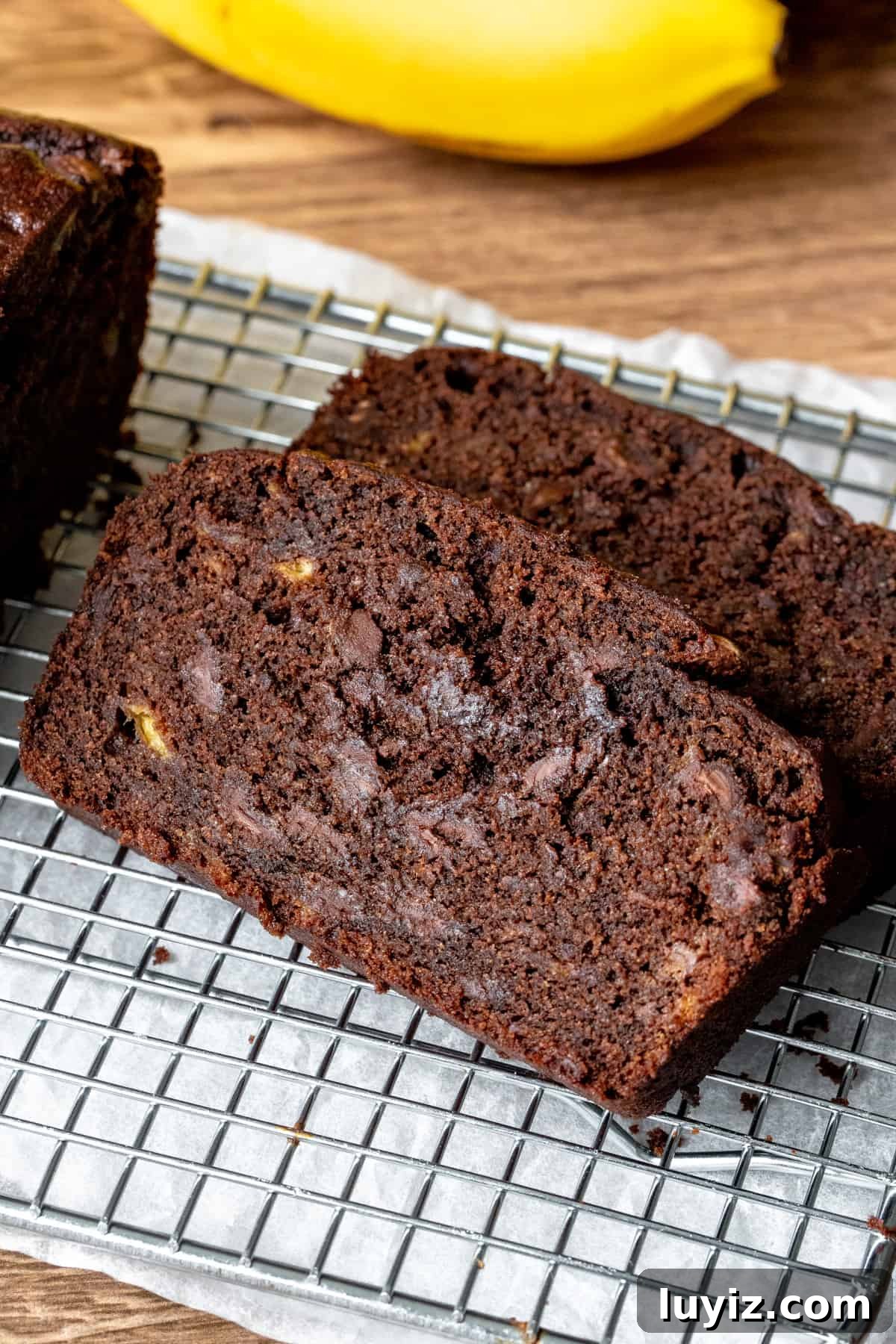 2 slices of chocolate banana bread on a cooling rack