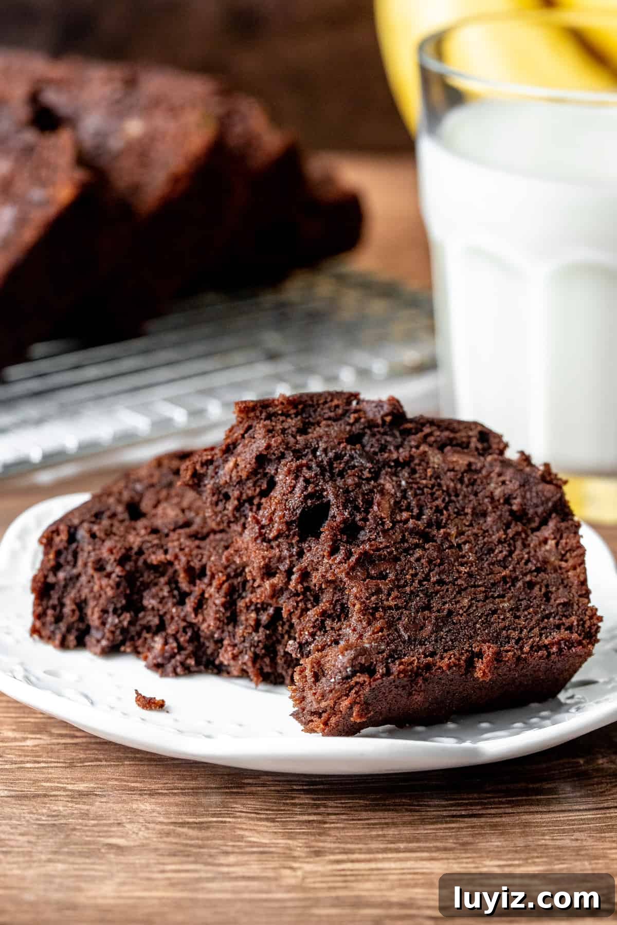 Slice of chocolate bread broken in half on a plate