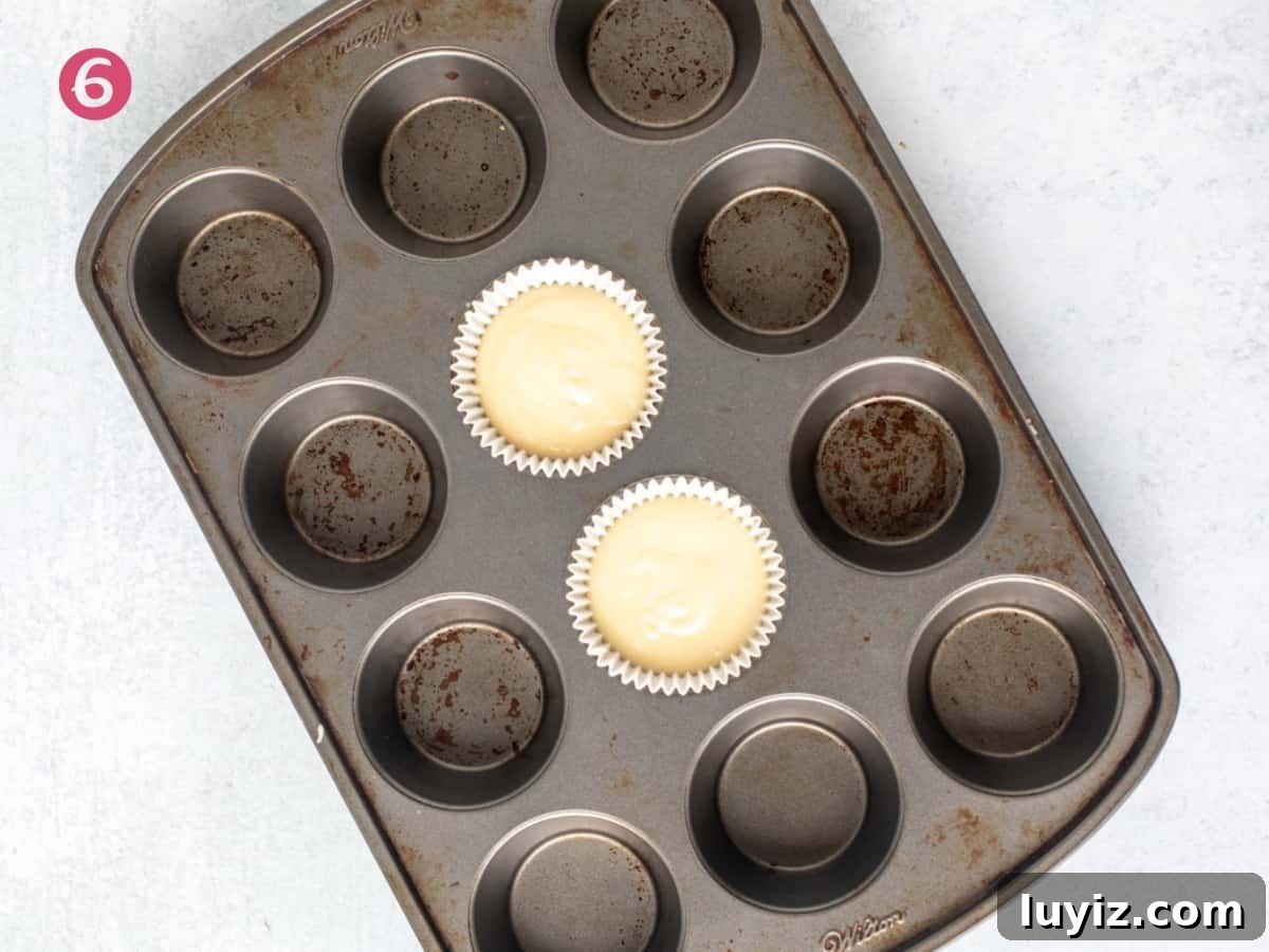 Perfect Vanilla Cupcakes for Two: Simple Small-Batch Recipe 5 Muffin pan with two unbaked vanilla cupcakes