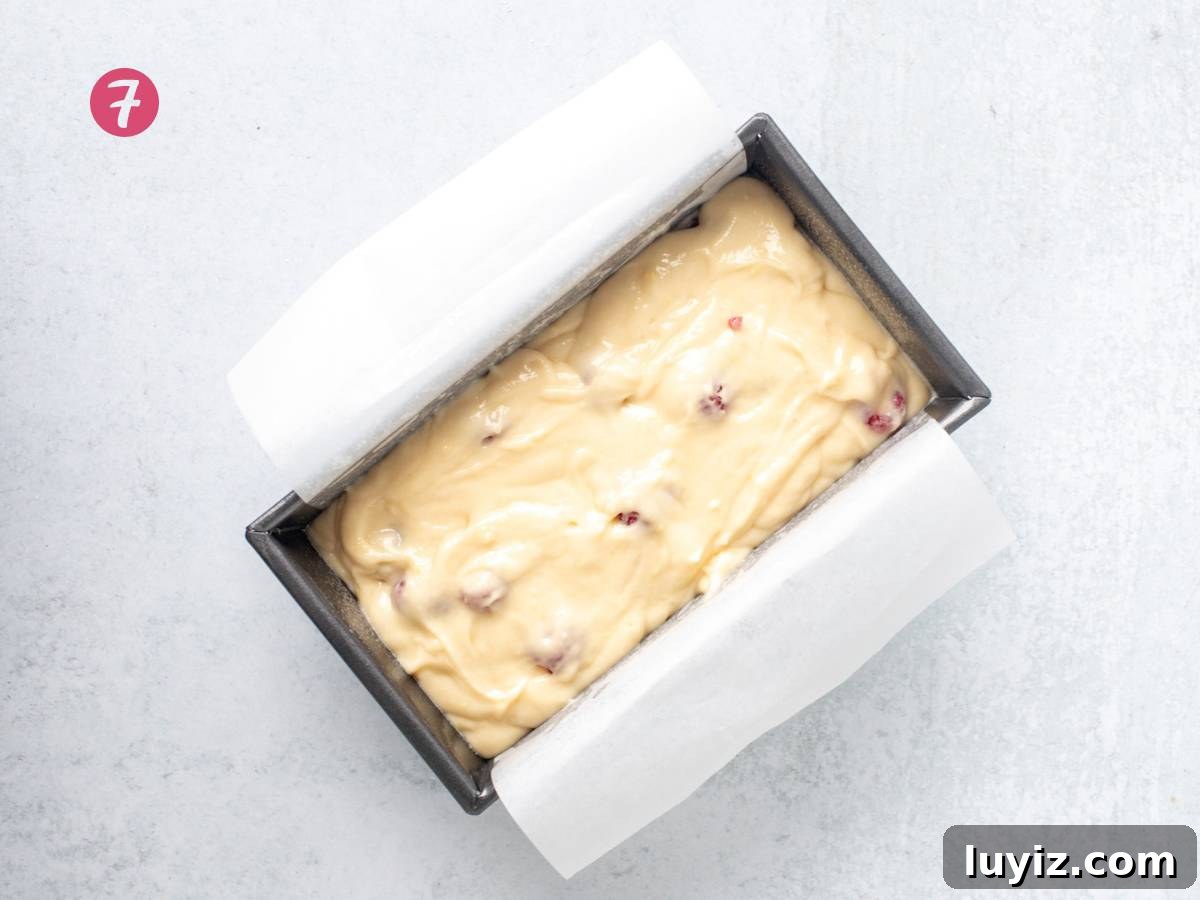 Zesty Lemon Raspberry Quick Bread Recipe 7 Lined loaf tin with unbaked lemon raspberry loaf