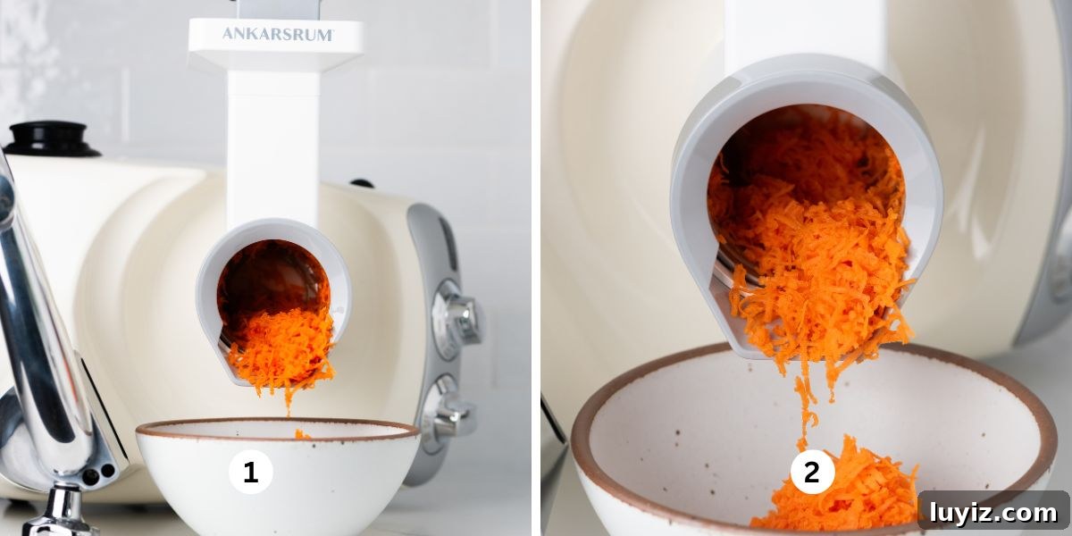 Carrot Cake Cookie Recipe: Moist, Spiced Cookies with Cream Cheese Frosting 6 Using an Ankarsrum mixer and vegetable cutter attachment with medium grater drum to grate carrot into a white ceramic bowl on a white quartz and tiled background.
