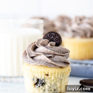 Decadent Oreo Cupcakes Recipe with Creamy Filling 8 Oreo cupcake with Oreo frosting with a glass of milk