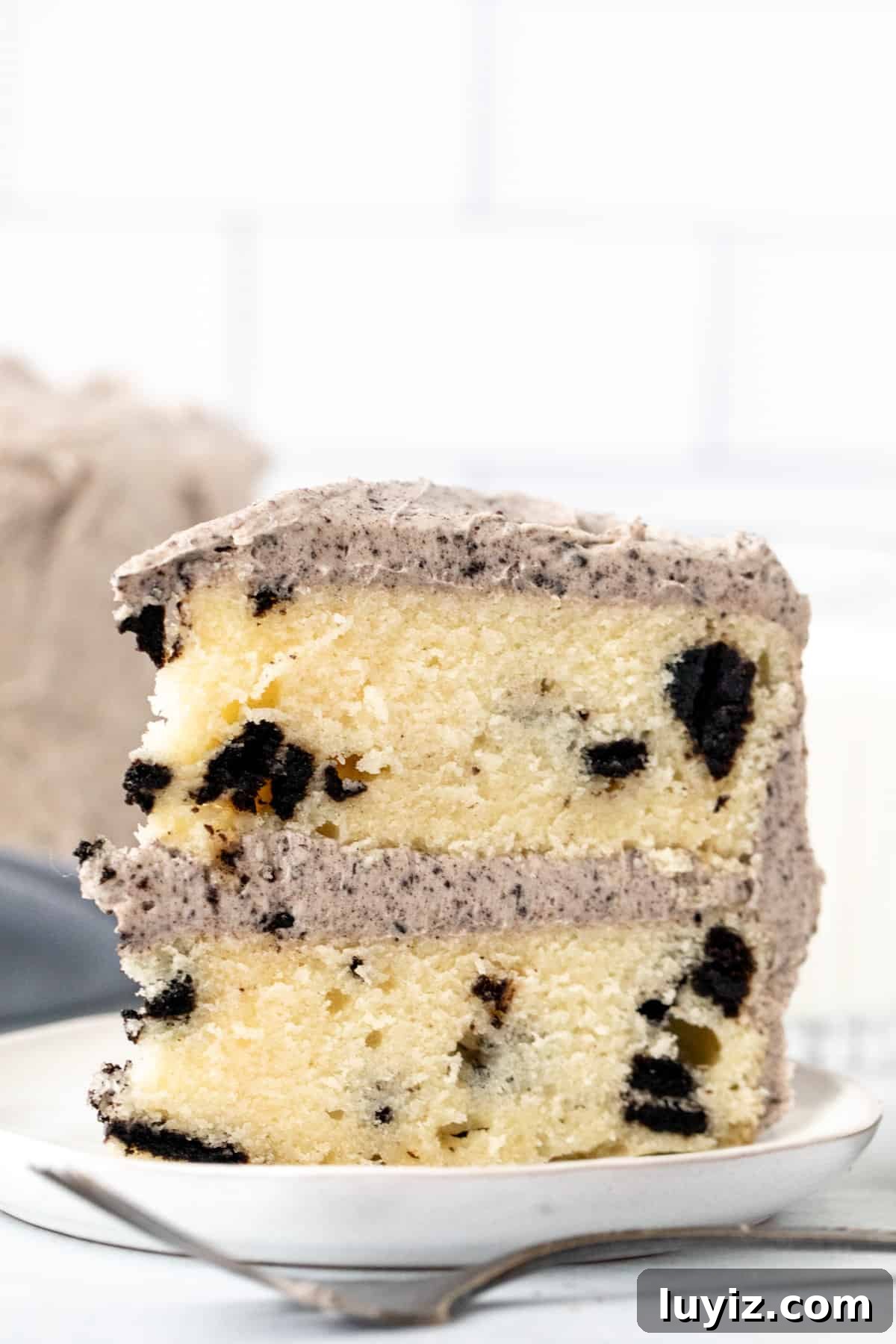 Oreo Layer Cake with Cookies & Cream Frosting 2 Slice of Oreo cake with cookies and cream frosting