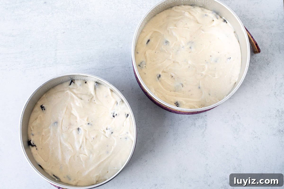 Oreo Layer Cake with Cookies & Cream Frosting 4 Two cake pans with unbaked Oreo cake, using cake strips
