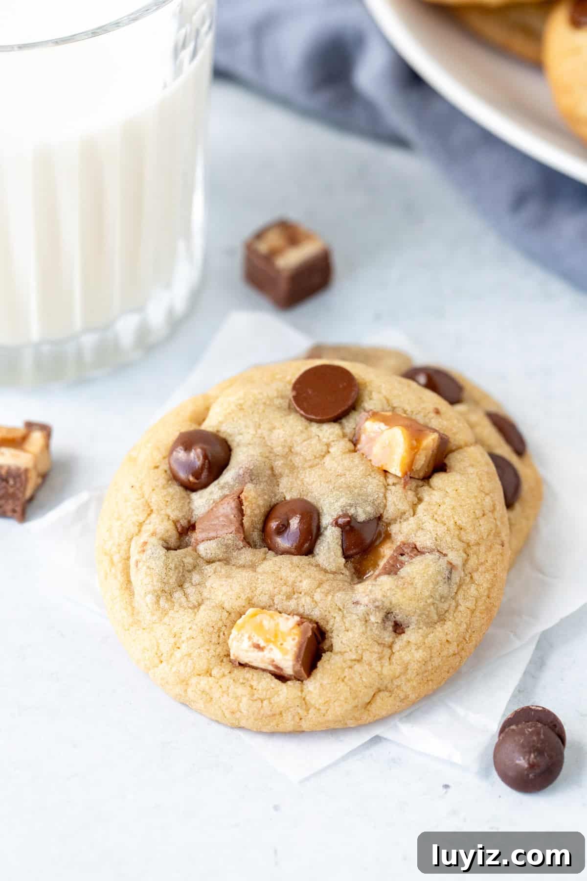Snickers Stuffed Chocolate Chip Cookies: Gooey Caramel & Peanuts 2 2 Snickers cookies with a glass of milk
