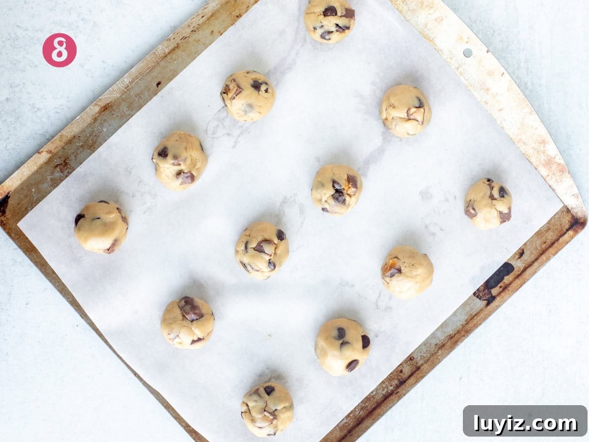 Snickers Stuffed Chocolate Chip Cookies: Gooey Caramel & Peanuts 6 Lined cookie sheet of unbaked Snickers cookie dough balls