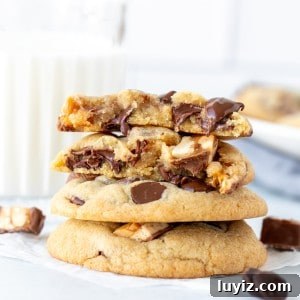 Stack of Snickers cookies, with top cookie broken in half