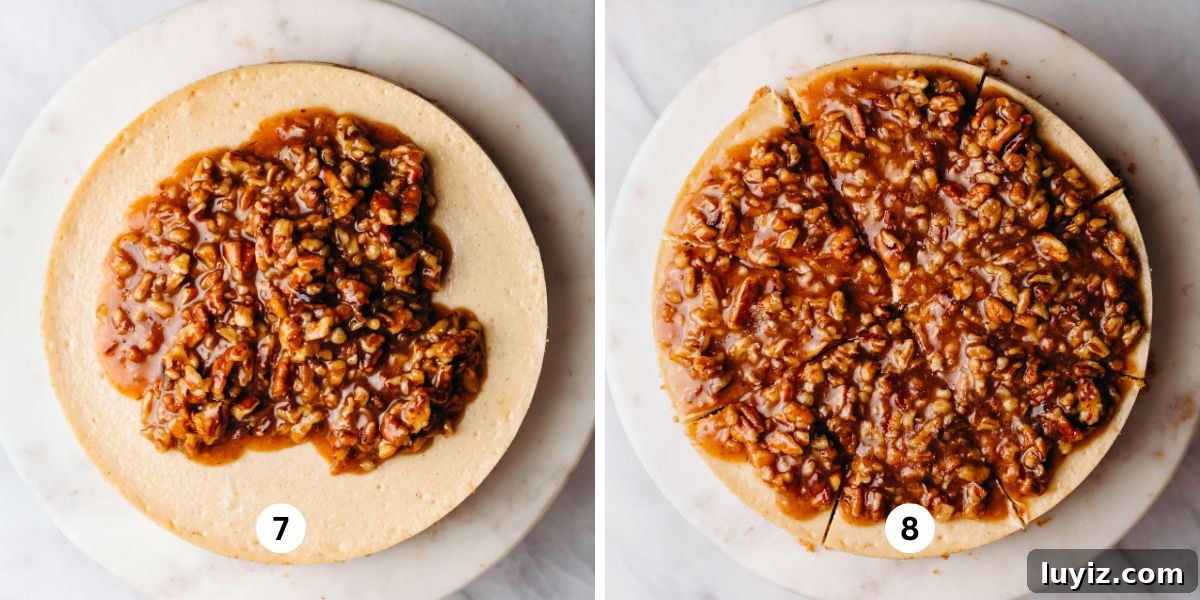 Pecan Pie Cheesecake Recipe — Decadent Homemade Dessert 14 Adding pecan pie topping to a cooled cheesecake on a white marbled cake stand on a white background.