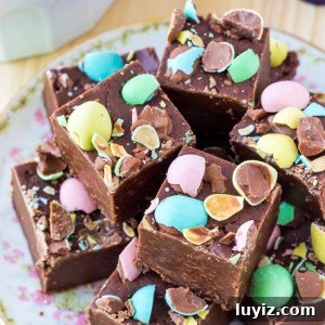 Decadent Easter Chocolate Fudge Recipe for Spring Dessert 6 Chocolate fudge that's smooth, creamy & topped with mini eggs. Perfect for Easter.