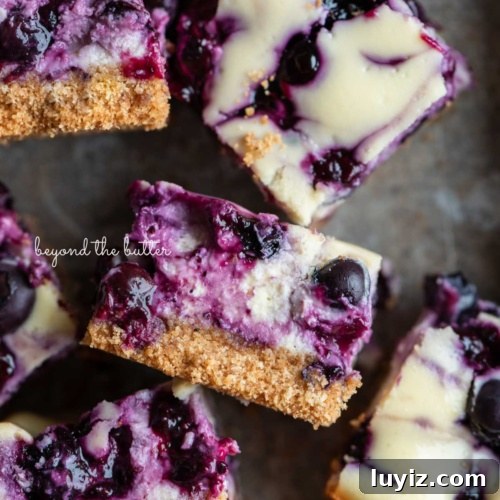 15 Delightful Easter Desserts to Impress Your Guests 16 Sliced blueberry swirl cheesecake bars randomly placed in a vintage baking tin.